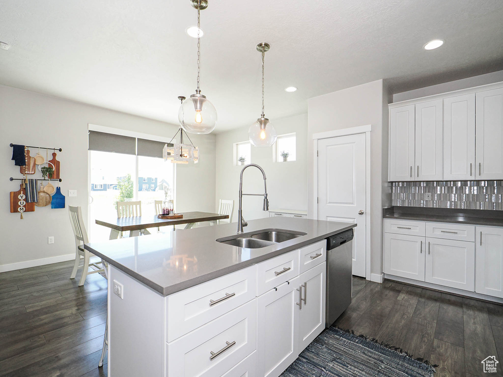 Kitchen featuring a sink, stainless steel dishwasher, dark wood-style floors, a center island with sink, and recessed lighting
