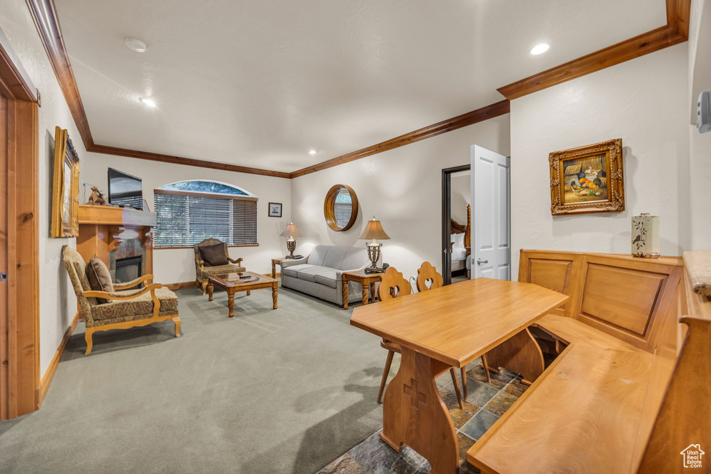 Dining space with ornamental molding, carpet floors, recessed lighting, and baseboards