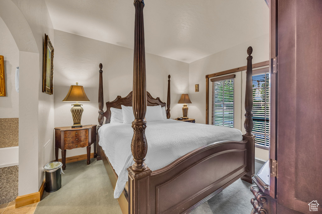 Bedroom featuring carpet flooring, baseboards, and access to exterior