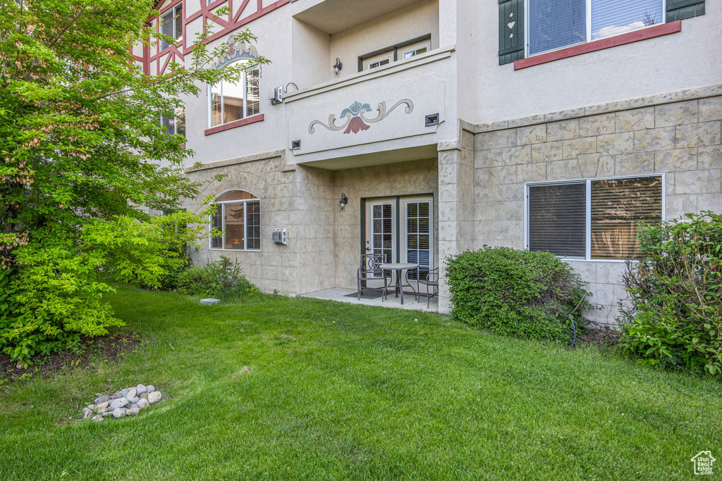 Exterior space featuring a yard and stucco siding