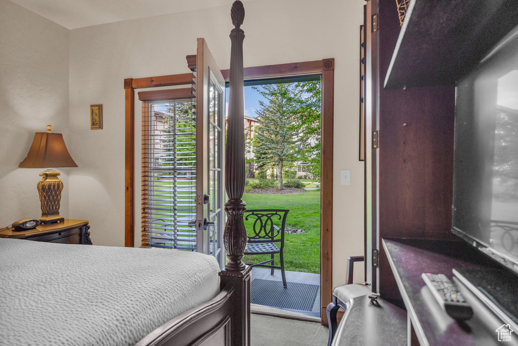 Bedroom featuring access to outside and carpet floors