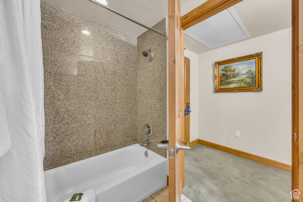 Full bath with shower / bathtub combination with curtain and baseboards