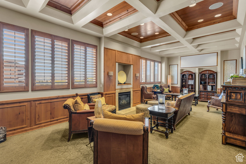 Living room featuring light carpet, coffered ceiling, beamed ceiling, a fireplace, and recessed lighting