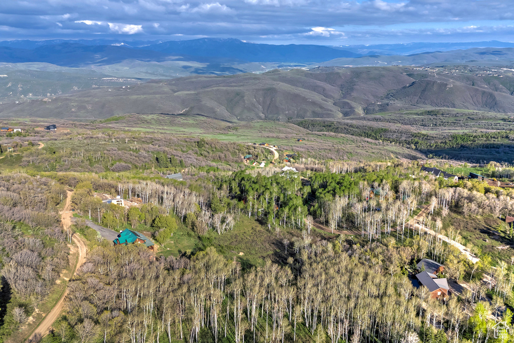 Aerial view of property\'s location featuring a mountainous background