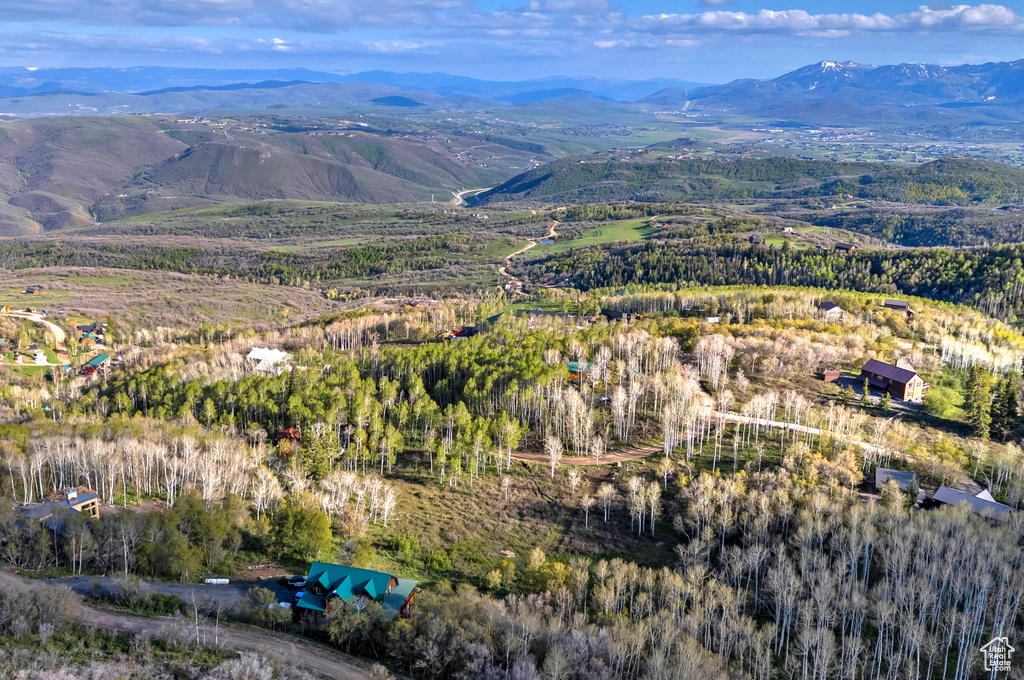 Aerial overview of property\'s location featuring a mountainous background