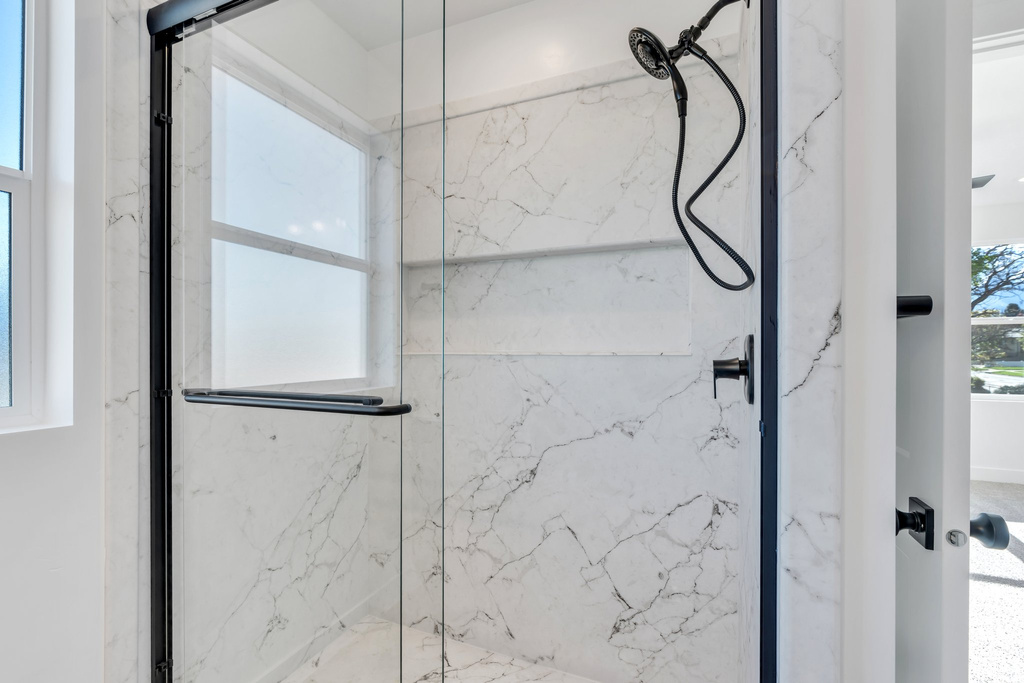 Bathroom featuring a marble finish shower