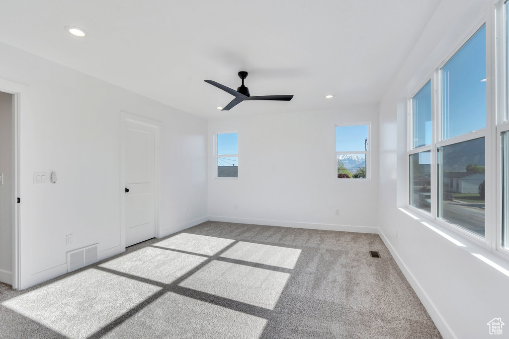Carpeted spare room with baseboards, recessed lighting, and a ceiling fan