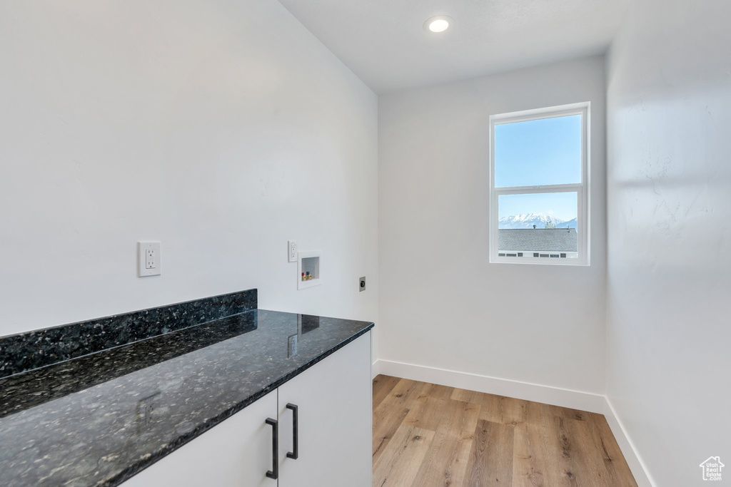 Washroom featuring hookup for an electric dryer, hookup for a washing machine, baseboards, light wood-style floors, and recessed lighting