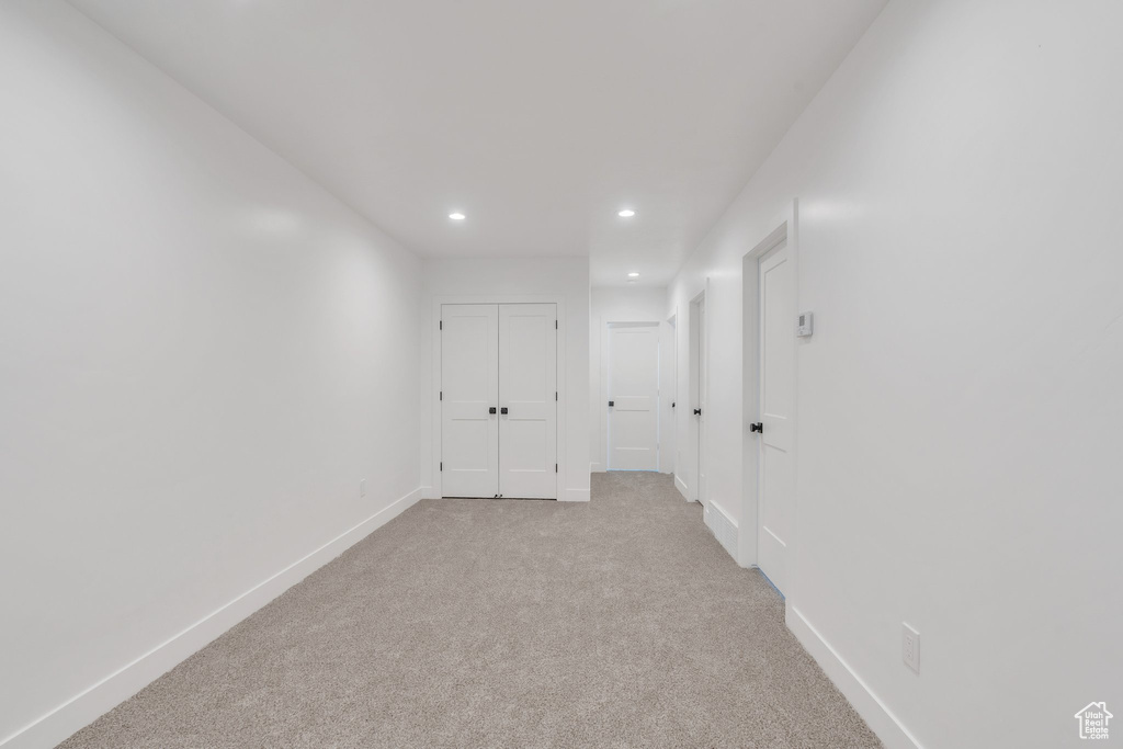 Hallway with recessed lighting, carpet floors, and baseboards