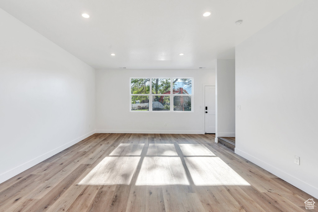 Unfurnished room with baseboards, recessed lighting, and light wood-type flooring