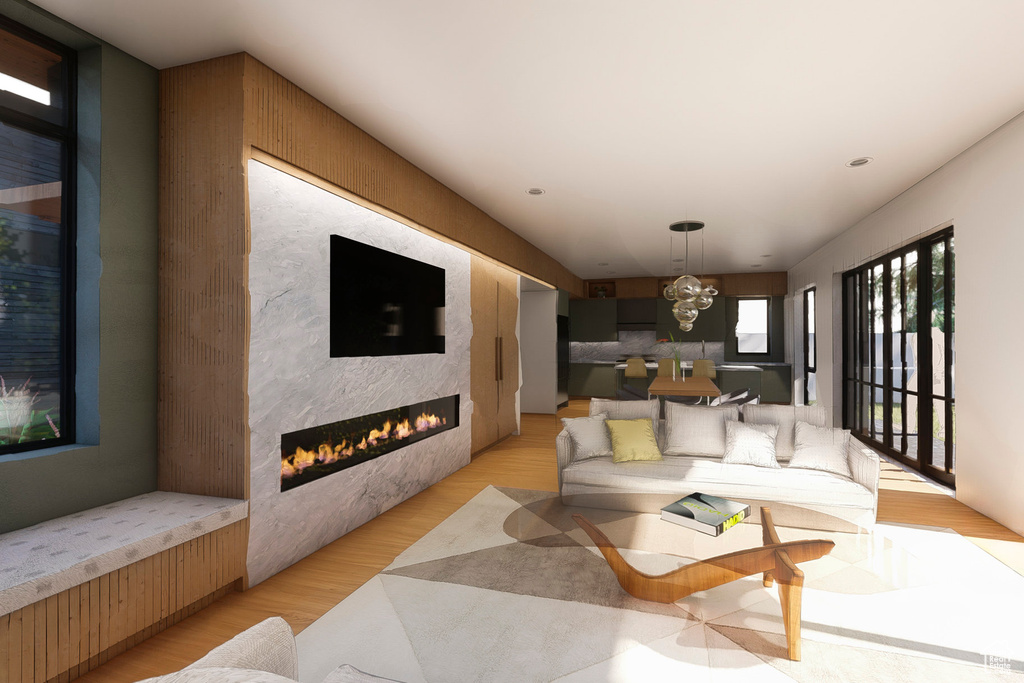 Living area featuring a glass covered fireplace and light wood-style flooring