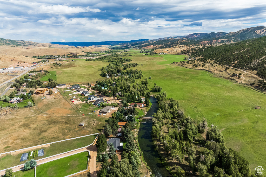 Aerial view of property and surrounding area featuring rural landscape and mountains