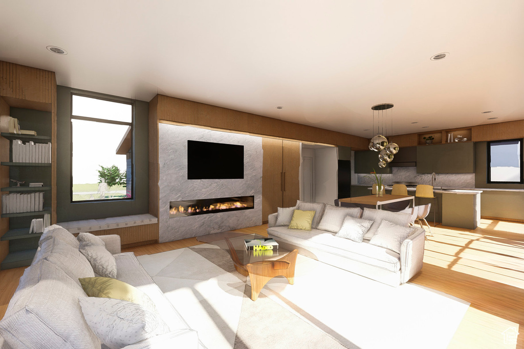 Living room featuring light wood-style flooring and a large fireplace