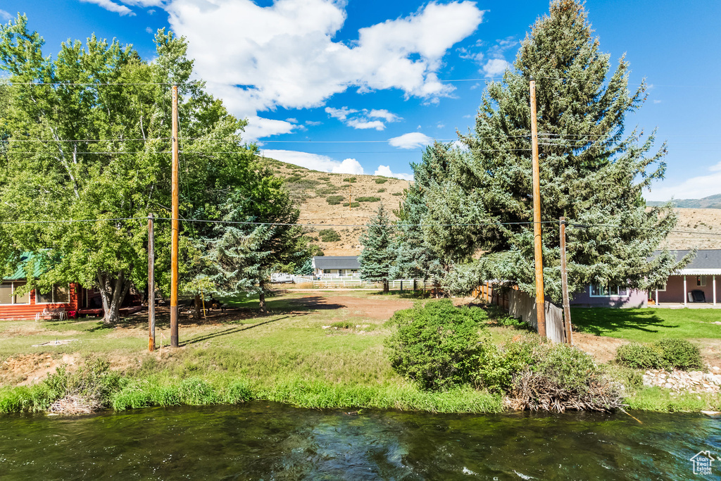 View of yard featuring a water and mountain view