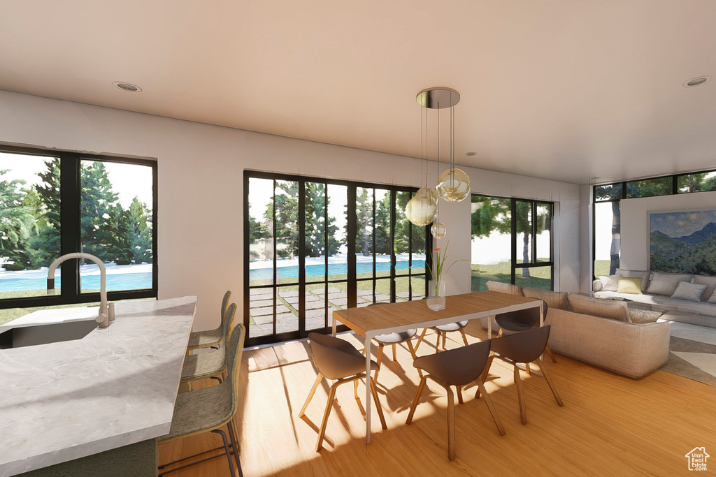Dining area with light wood-style floors and recessed lighting