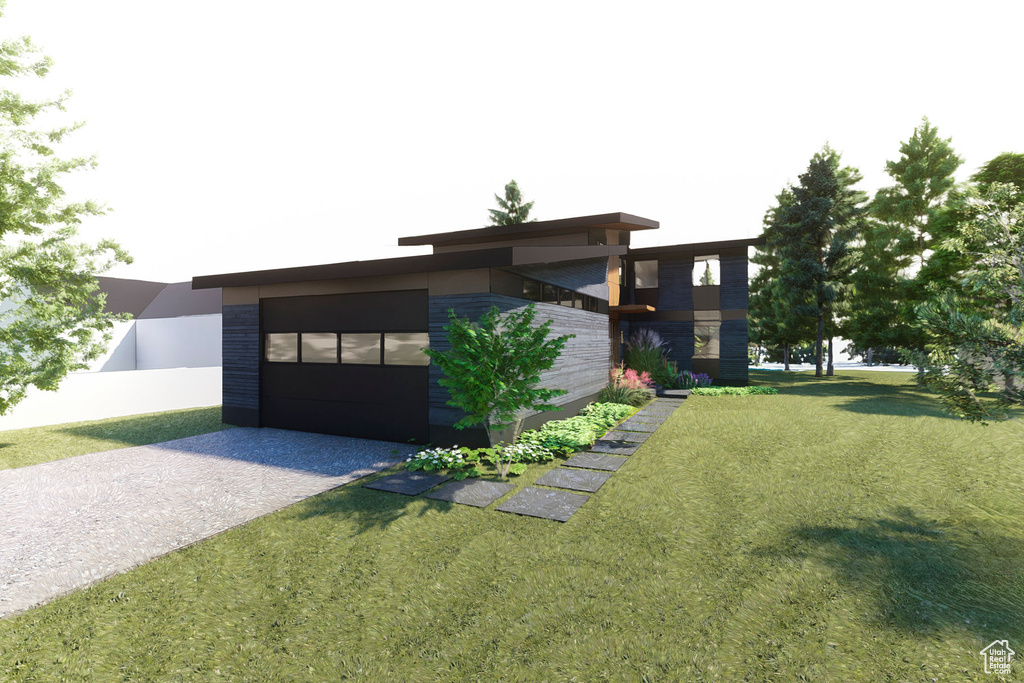 View of grassy yard featuring driveway and a garage