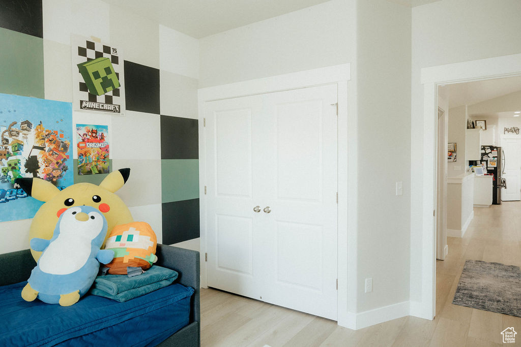 Bedroom with wood finished floors and baseboards