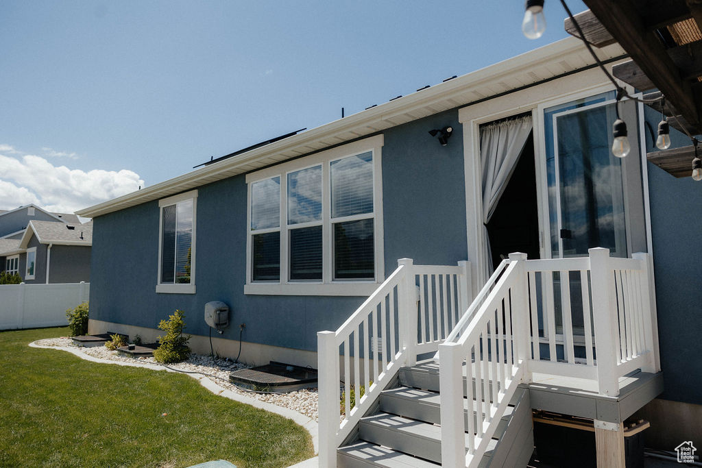 Rear view of property with stucco siding