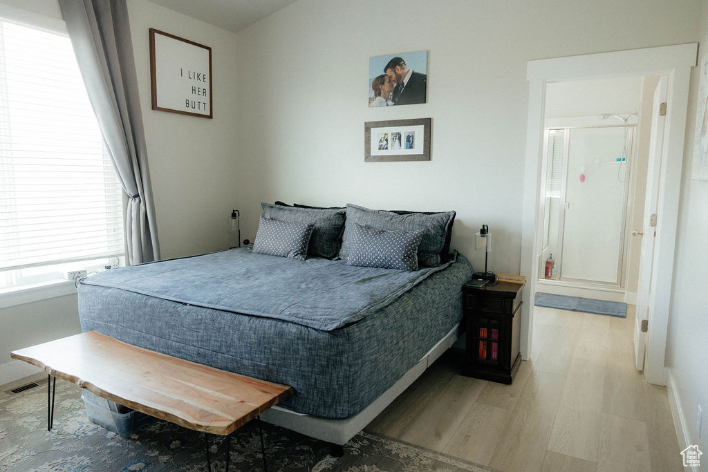 Bedroom featuring wood finished floors and baseboards