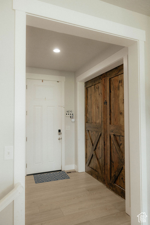 Foyer entrance featuring light wood-style flooring and recessed lighting