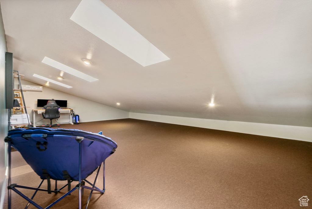 Additional living space with a skylight, lofted ceiling, an office area, recessed lighting, and carpet