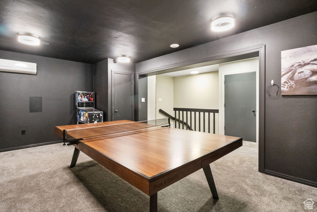 Game room with carpet flooring and a wall unit AC