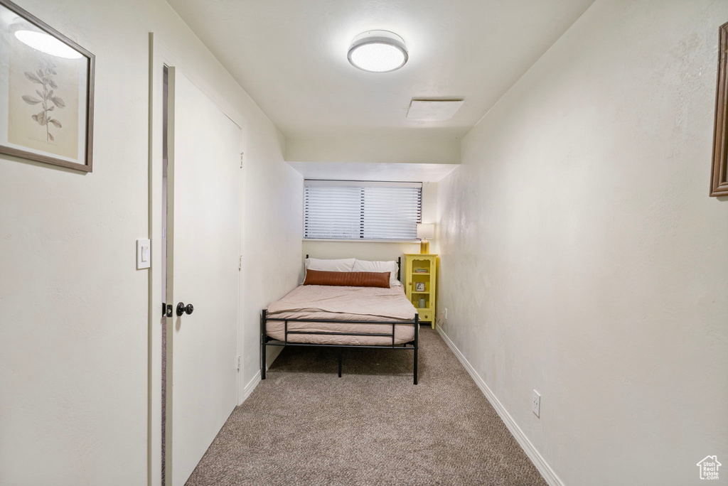 Bedroom featuring carpet floors and baseboards