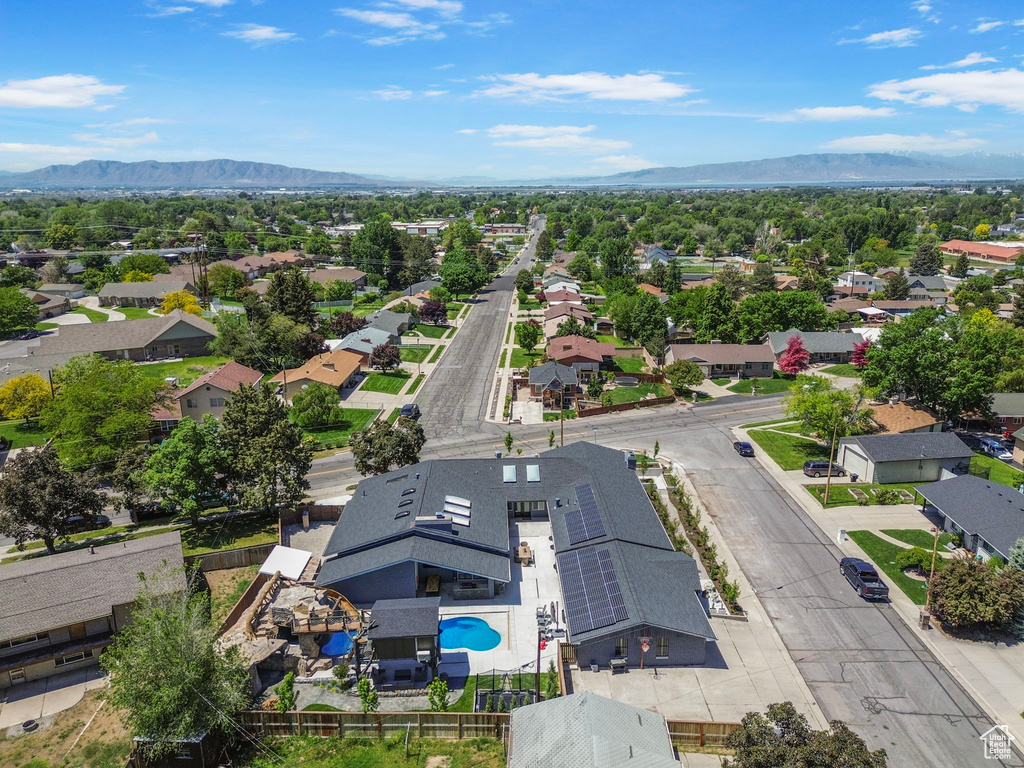 Aerial view of residential area with mountains and a pool
