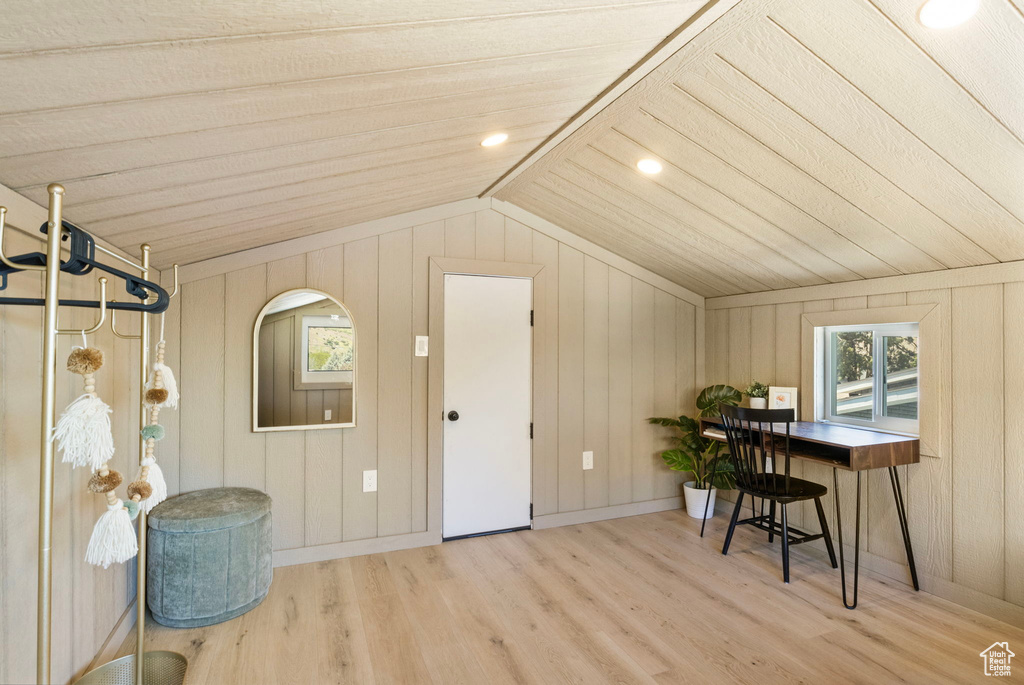 Bonus room featuring wood finished floors, vaulted ceiling, healthy amount of natural light, wooden walls, and wooden ceiling