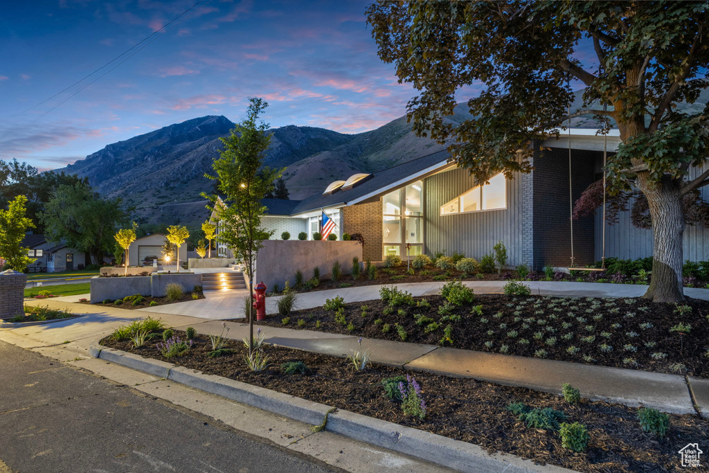 View of front of house with a mountain view and brick siding