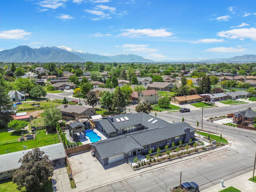 Aerial view of residential area with mountains and a pool