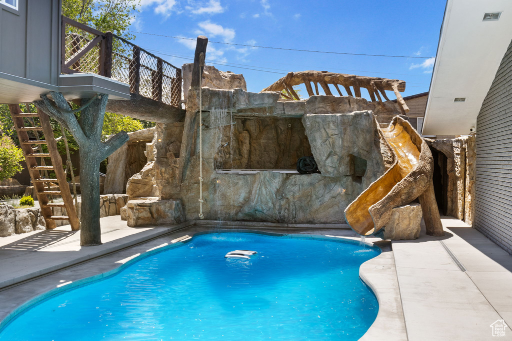 View of pool featuring stairway