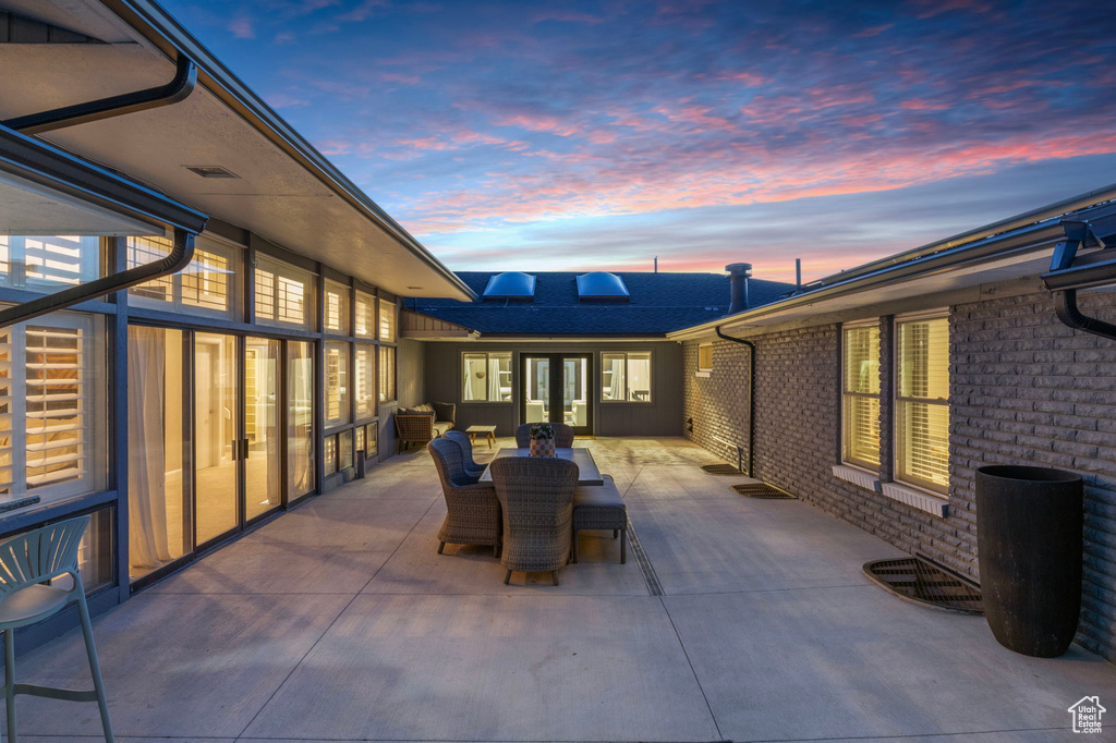 Patio terrace at dusk featuring a patio area and outdoor dining space