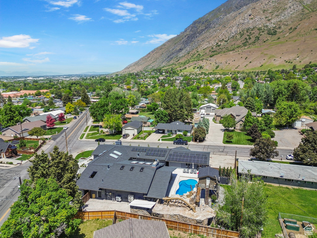 Aerial view of residential area featuring mountains and a pool