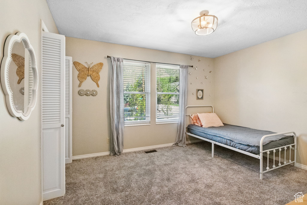 Bedroom with carpet and baseboards