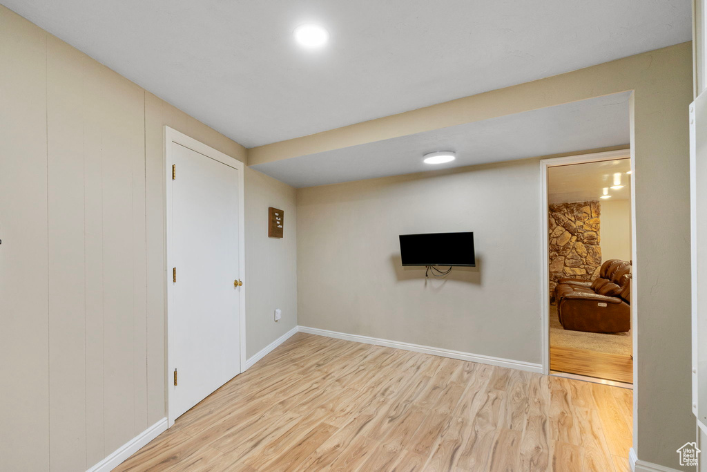 Below grade area featuring light wood finished floors and baseboards