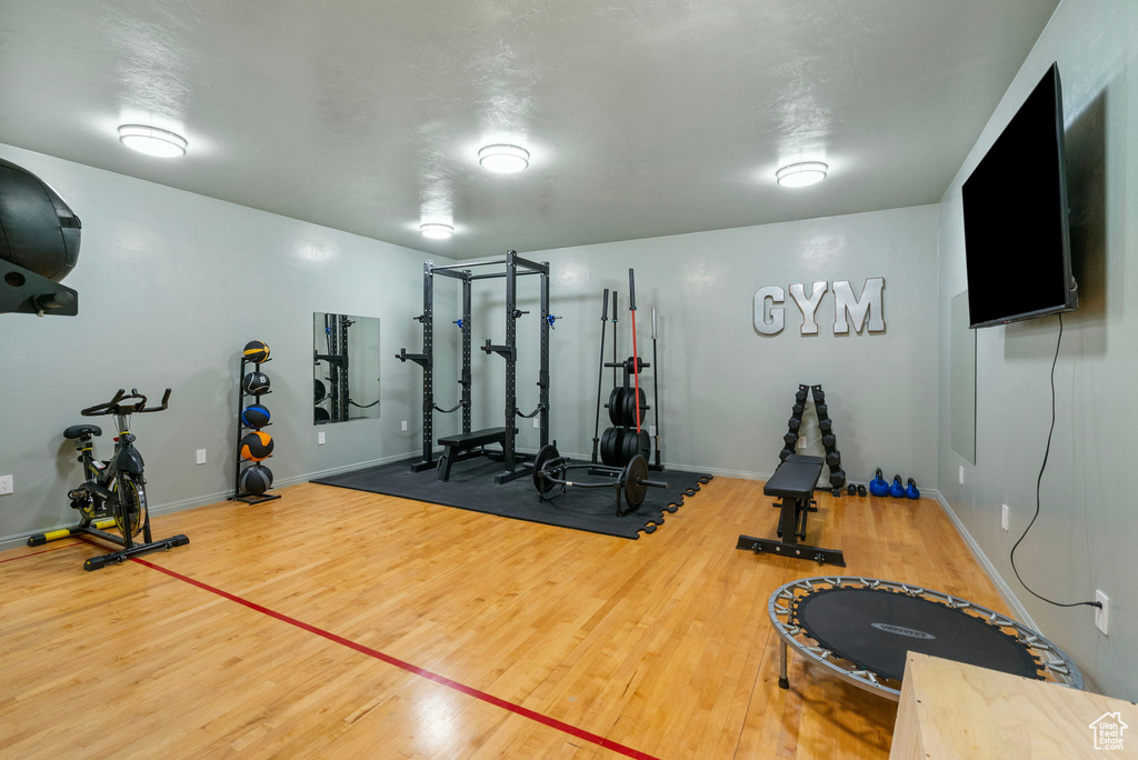 Workout area featuring wood finished floors and baseboards