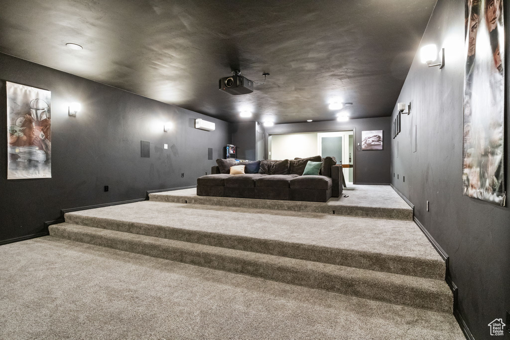 Cinema featuring carpet floors, a wall mounted air conditioner, and baseboards
