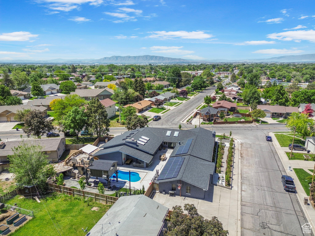 Aerial view of residential area featuring a pool area and mountains