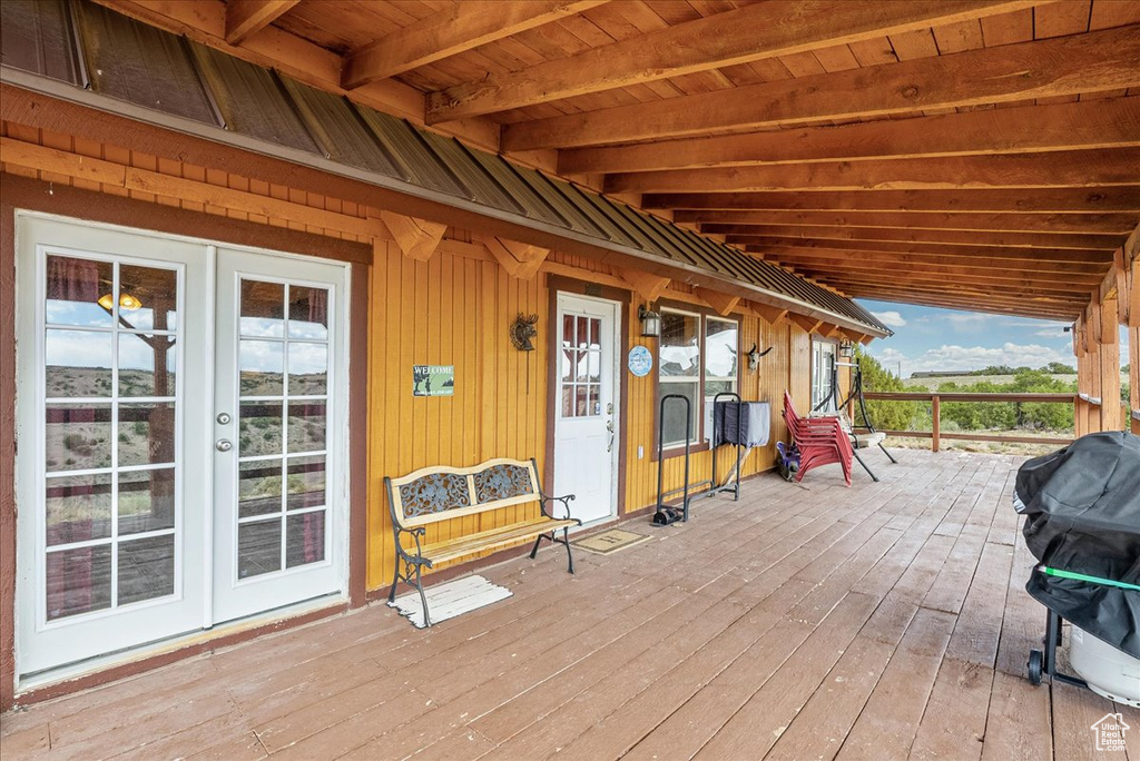 Wooden terrace with french doors and area for grilling