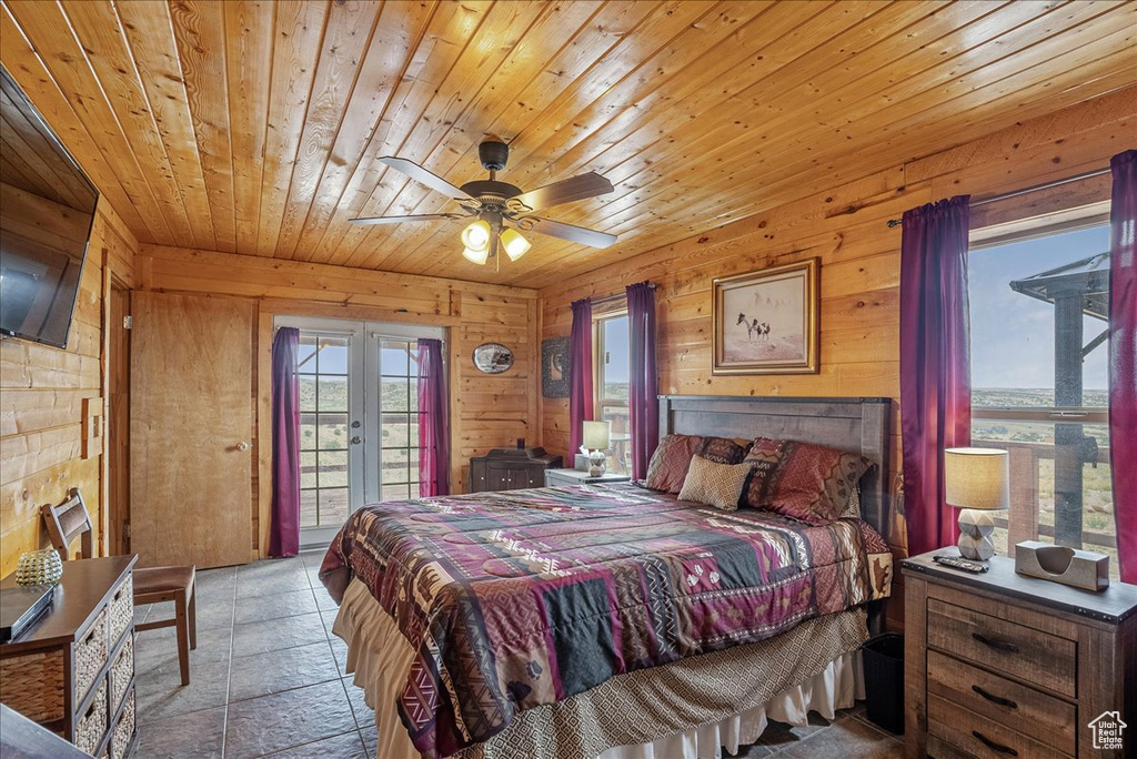 Bedroom featuring access to outside, wood ceiling, wood walls, french doors, and ceiling fan