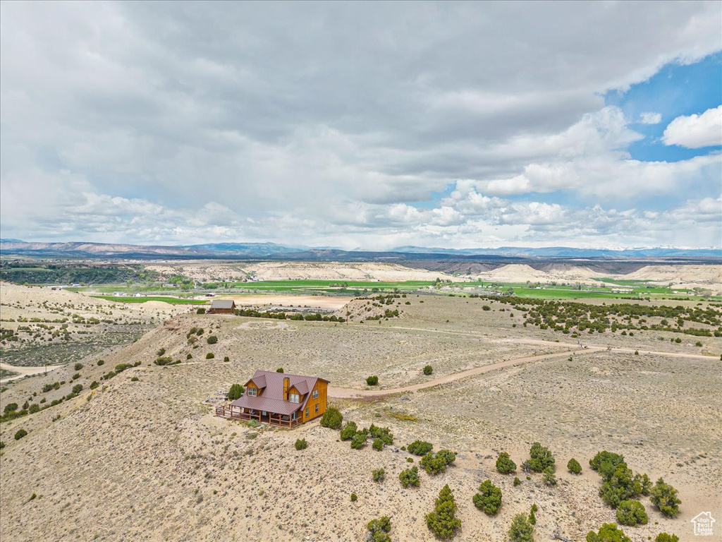 Aerial view of sparsely populated area featuring a desert landscape and a mountainous background