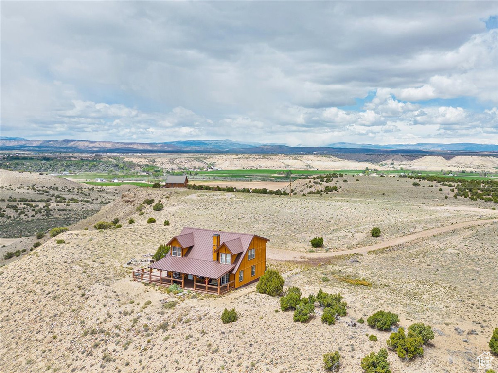 Aerial view of sparsely populated area featuring a desert landscape and a mountainous background