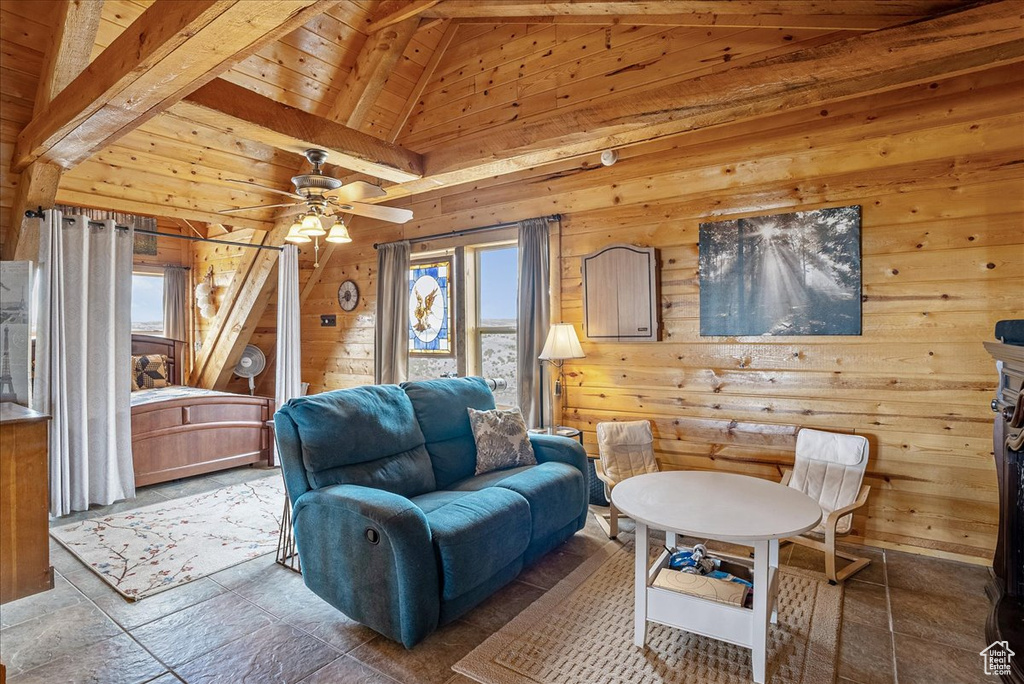 Living room with wooden walls, ceiling fan, and wooden ceiling