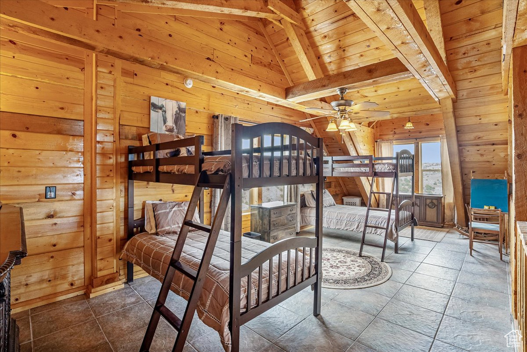 Bedroom with wood walls and wooden ceiling