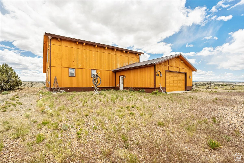 View of outbuilding with an attached garage and an outdoor structure