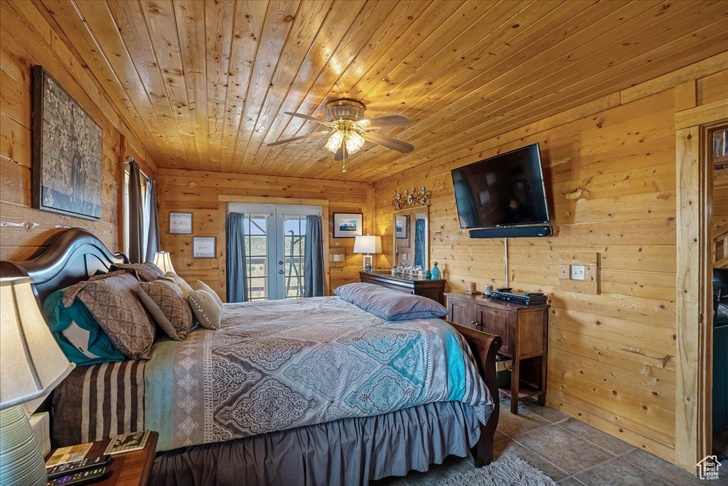 Bedroom featuring french doors, wood ceiling, wood walls, and access to outside