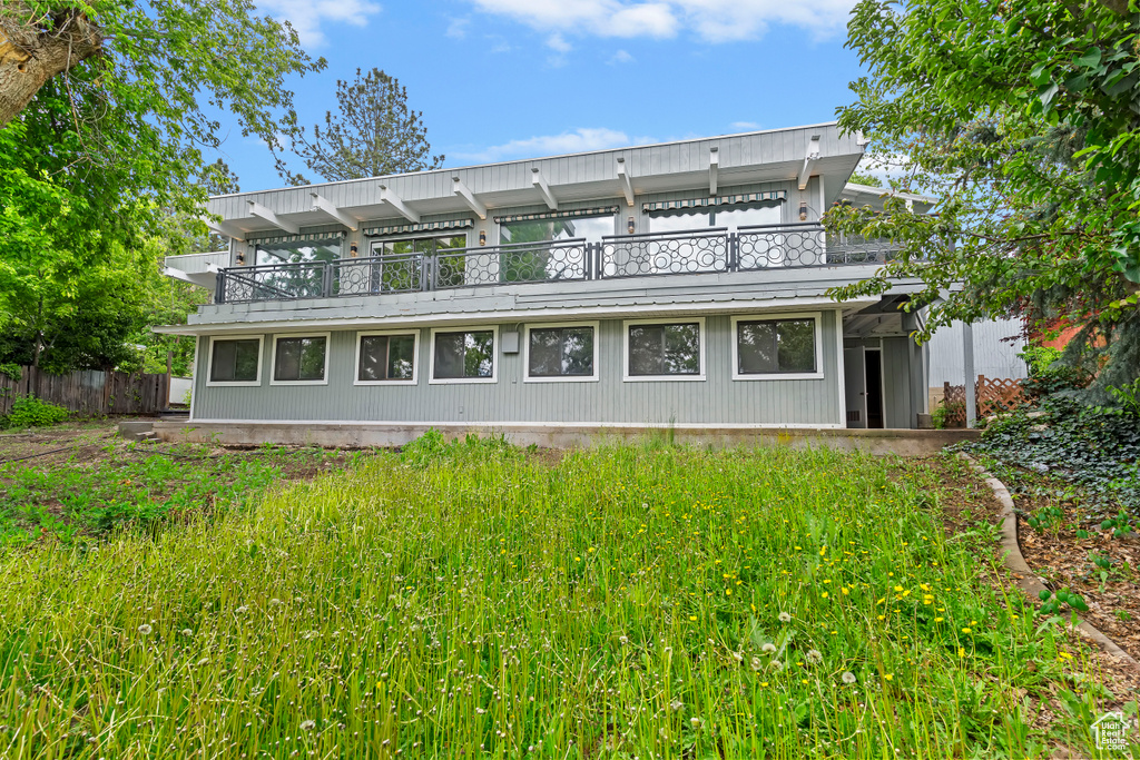 Rear view of property with a balcony