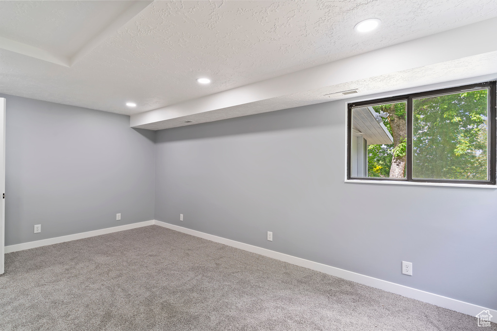 Basement featuring carpet, recessed lighting, a textured ceiling, and baseboards
