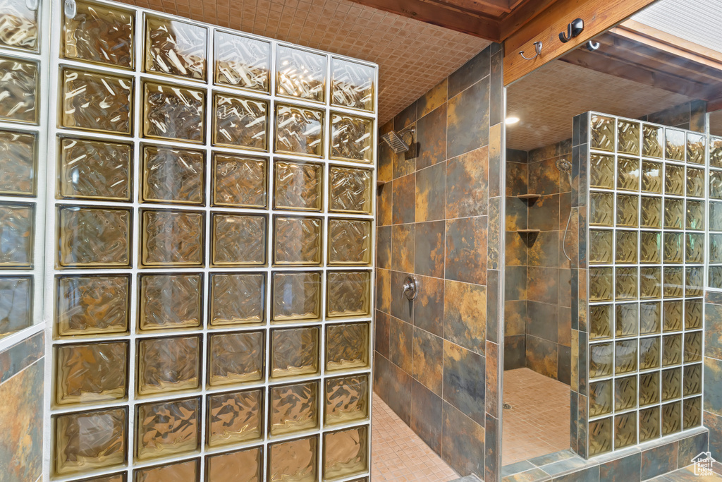 Bathroom with a walk in shower and tile walls